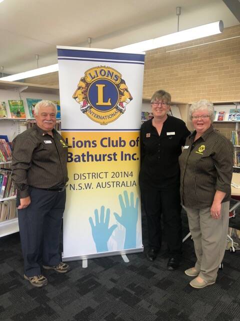 IMPORTANT MESSAGE: Dominic and Judy Chircop from the Lions Club of Bathurst with Bathurst Library's Jane Cook.