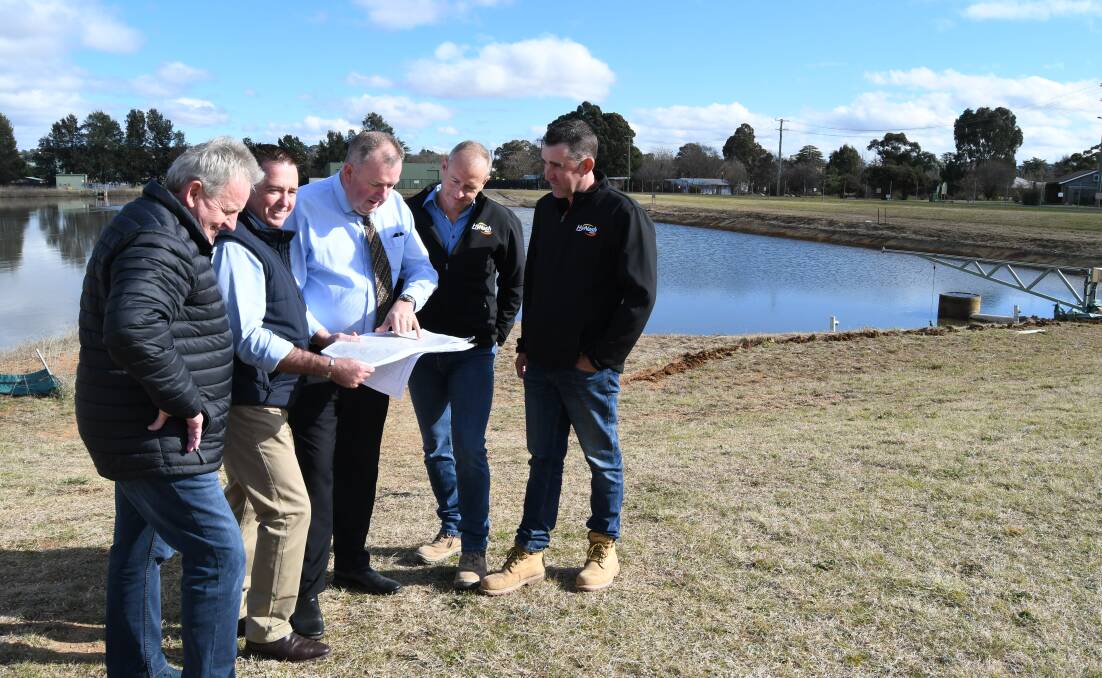 Mayor Robert Taylor, Deputy Premier Paul Toole, council's director of engineering services Darren Sturgiss and Hynash Constructions' Tim Ditchfield and Phillip Hewitt look at plans for the stormwater harvesting scheme. Photo: RACHEL CHAMBERLAIN