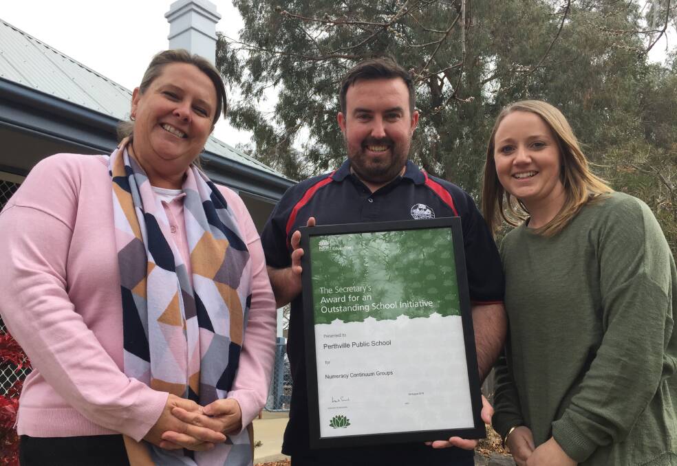 CLASS ABOVE: Perthville Public principal Jodie James and assistant principals Kurt Dickson and Kirralee Naylor with the award the school won for its numeracy initiative.