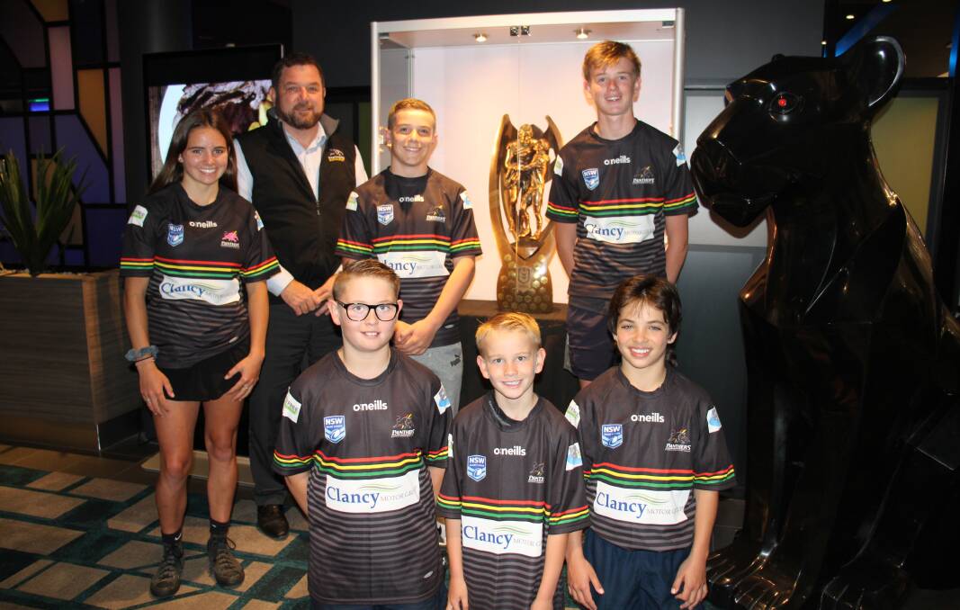 THE DREAM: Bathurst Panthers juniors Abbey Carter, Logan Coombes, Charlie Fischbeck, Jackson Fischbeck, Cruz Fischbeck and Riley Carter excited to see the Penrith Panthers' winning trophy on display at Panthers Bathurst leagues club with general manager John Fearnley.