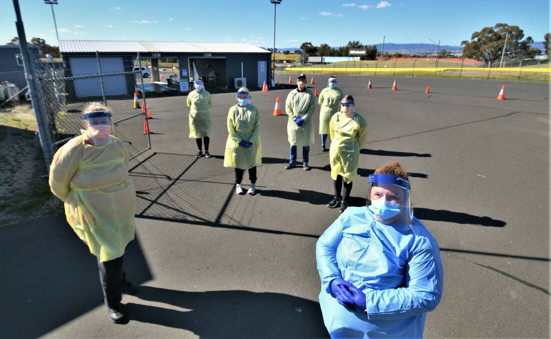 FRONTLINE: Respiratory specialist collector Hope Blazely with staff at the COVID drive-through clinic at Mount Panorama. Photos: CHRIS SEABROOK 081821covidchk1