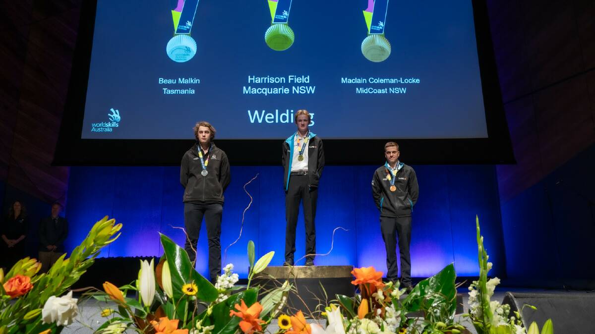 Harrison Field (centre) receives his gold medal at the WorldSkills Australia 2023 National Championships in Melbourne. Picture supplied.