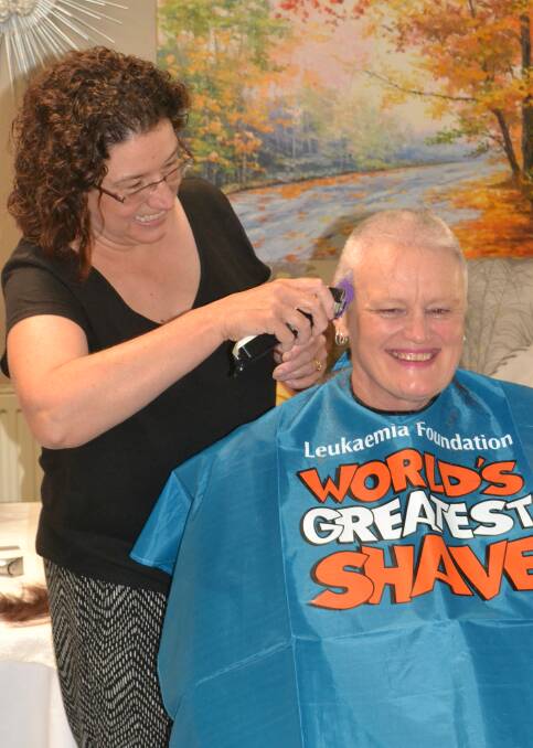 THERE IT GOES: Renee Fowler from Donna Callista Salon shaves Sue Storrier's hair at RFBI Bathurst Masonic Retirement Village. 031418shave