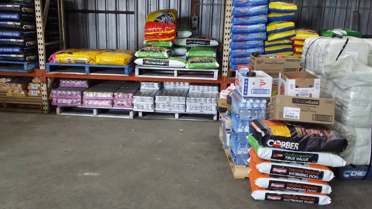 HERE TO HELP: Some of the donated items for the 2BS Gold/Town and Country “Thumbs Up for Farmers” drought support program. Note the cartons of bottled spring water. Vicki also has containers and water available for anyone who requires it.