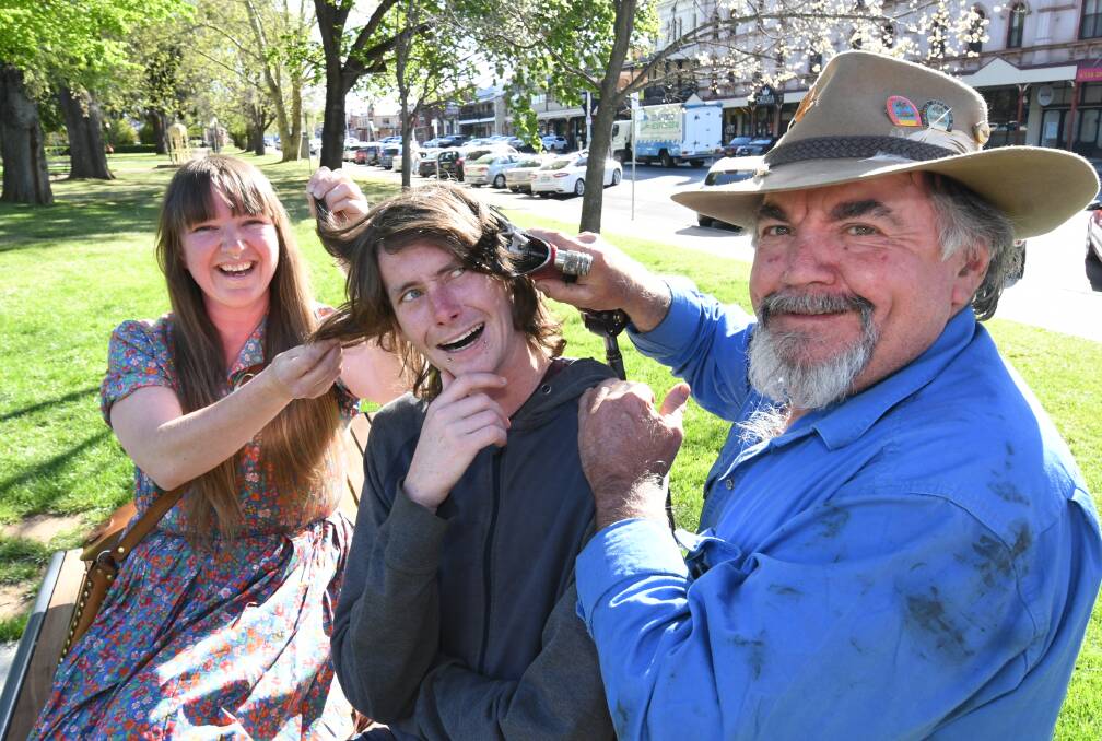 CUT ABOVE: Alicia and Harold Colley prepare Mitch Chifley (middle) for his shear handpiece haircut. Photo: CHRIS SEABROOK 100919cshearing