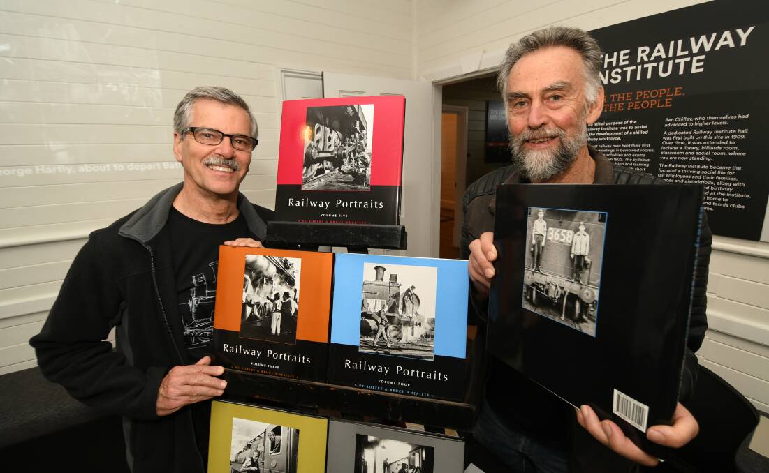 LIFETIME PASSION: Brothers Bruce, of Beecroft, and Robert Wheatley, of Wentworth Falls, with their books of photos of the steam engine era in NSW. Photo: CHRIS SEABROOK 022220crlym8
