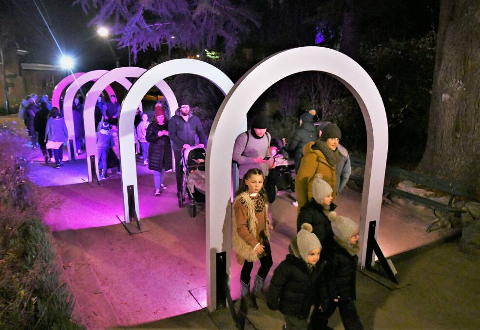 OUT AND ABOUT: Going through the arches in Machattie Park on Saturday evening at the Bathurst Winter Festival. Photo: CHRIS SEABROOK