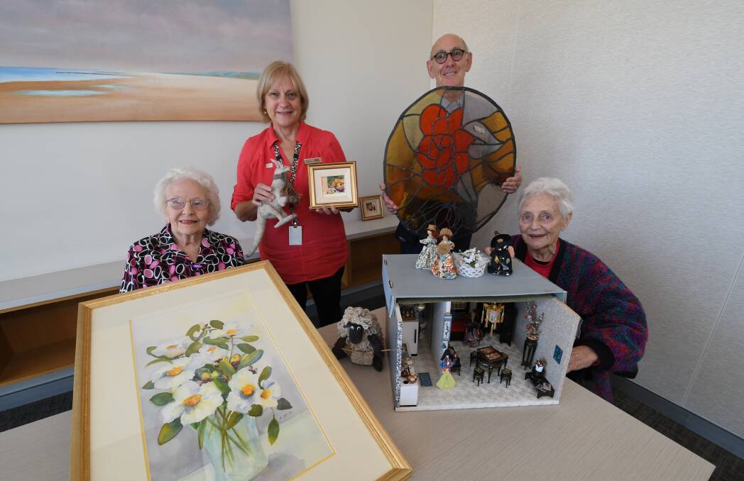 ON SHOW: Resident Margaret Young, Whiddon Kelso deputy director of care services Michelle Sharwood, activities officer Martin Raphael and resident Bep Keuning with works that will be on display during an art exhibition. 032618cwhidn1