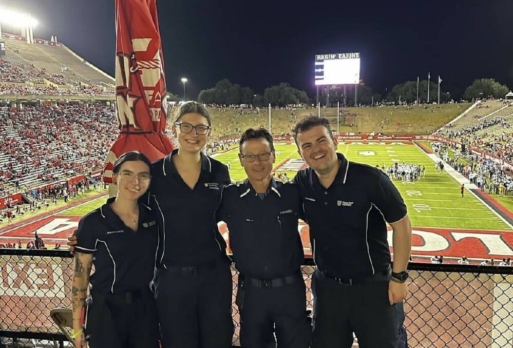CSU Bathurst student Erin Isaacs and fellow student Sofia Heszterenyiova with CSU paramedicine lecturer Tim Spokes and student Jarrod McInnis working at an American football game. Picture supplied.