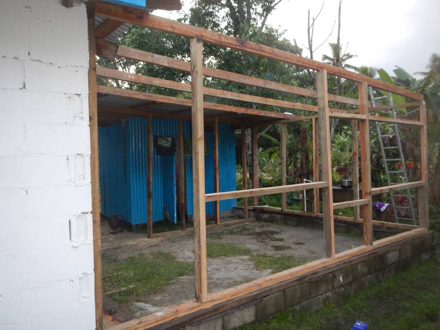 GOING UP: Building a house for a family in Fiji.