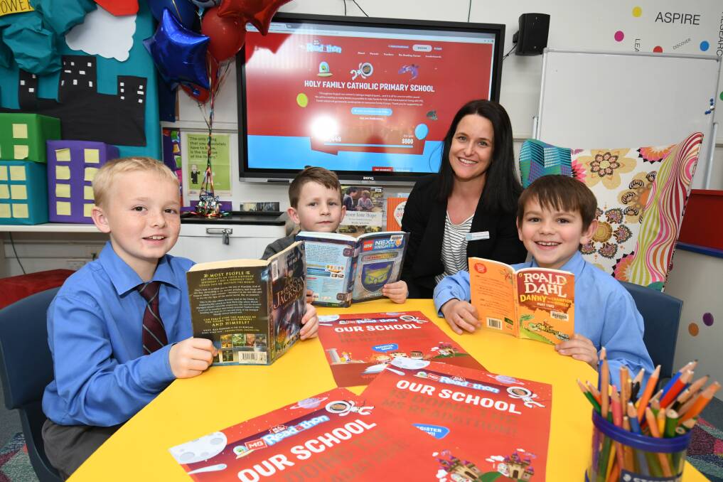 READ ALL ABOUT IT: Year four student Jett Sinclair, year one student Levi Harper and year two student Khaelan Lamond, pictured with teacher/librarian Melanie McGrath, are the leading MS Readathon fundraisers at Holy Family School. Photo: CHRIS SEABROOK 082619cmsbooks1