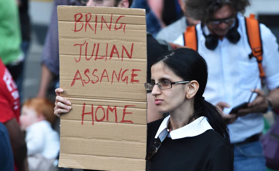 PLEA: A supporter of Julian Assange rallies outside the Victorian State Library in Melbourne. Photo: AAP IMAGE/JAMES ROSS