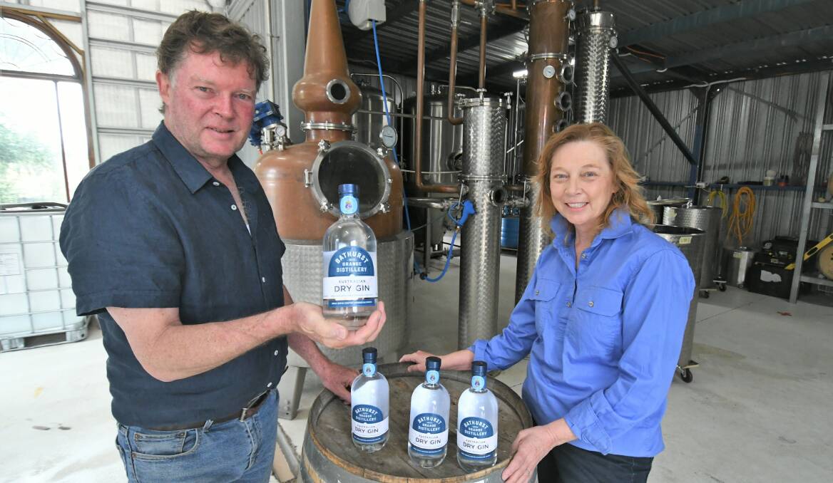 CELEBRATION: Toby and Sue Jones from the Bathurst Grange Distillery with bottles of dry gin for the HMAS Bathurst. Photo: CHRIS SEABROOK