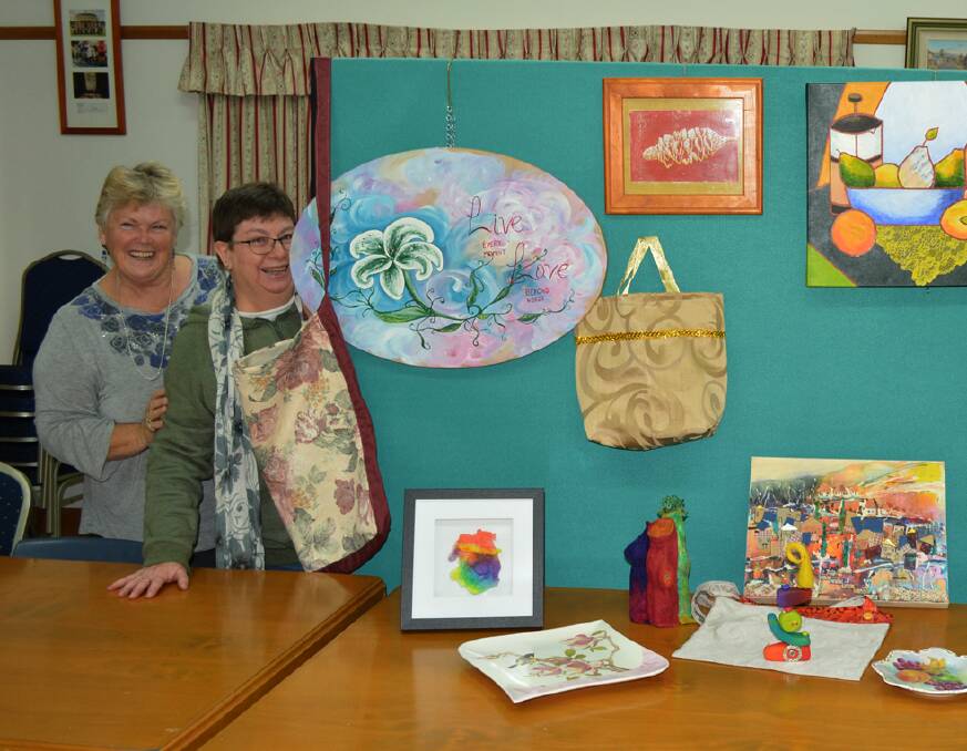 ENTER NOW: Evans Arts Council members Wendy-lou Tisdell and Ruth Heaton with entries for the group's art competition last year. Photo: SUPPLIED