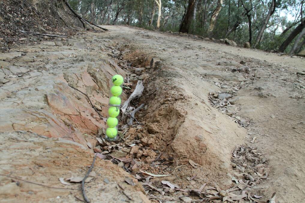 DEEP PROBLEMS: The Bridle Track Action Group has previously used tennis balls to show the poor state of the road. Photo: SUPPLIED