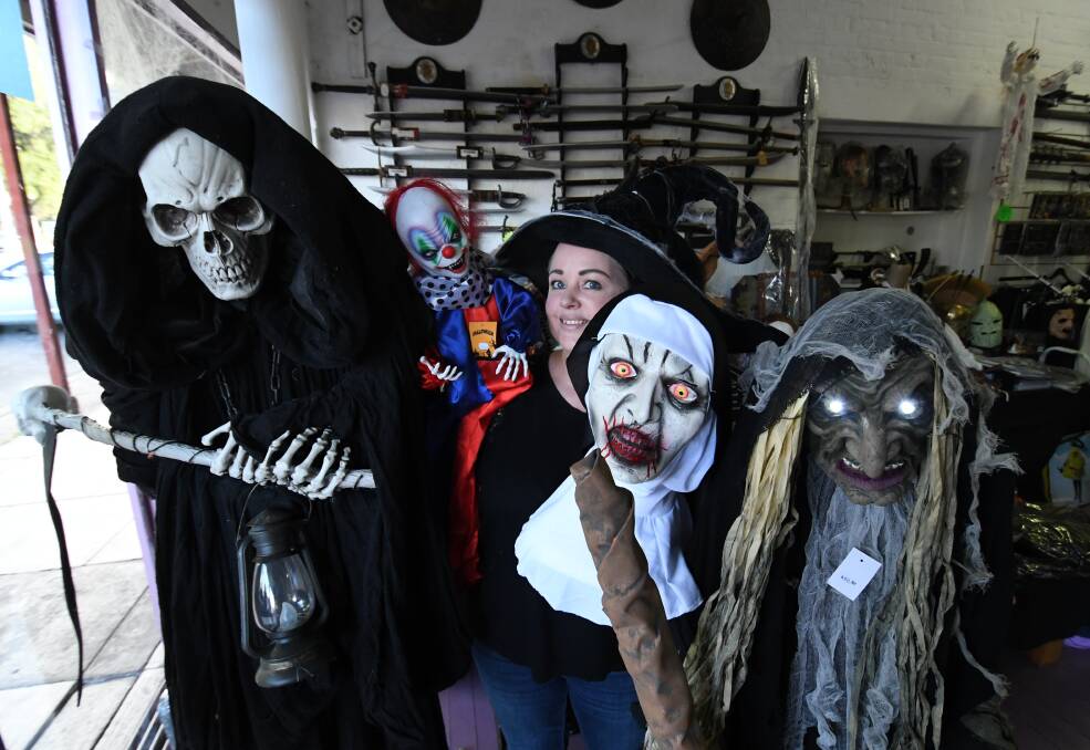 A SCARE IN THERE: Cosventure owner Kath Palma with a selection of spooky Halloween characters. Photo: CHRIS SEABROOK 102318challowen