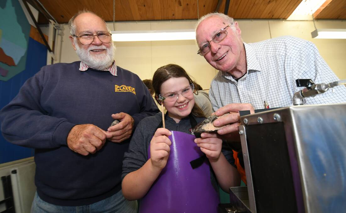 OPEN DAY: Bathurst Stamp, Coin, Collectables and Lapidary Club president Jeff West with Yvette Merlino and her grandfather Jim Merlino. Photo: CHRIS SEABROOK