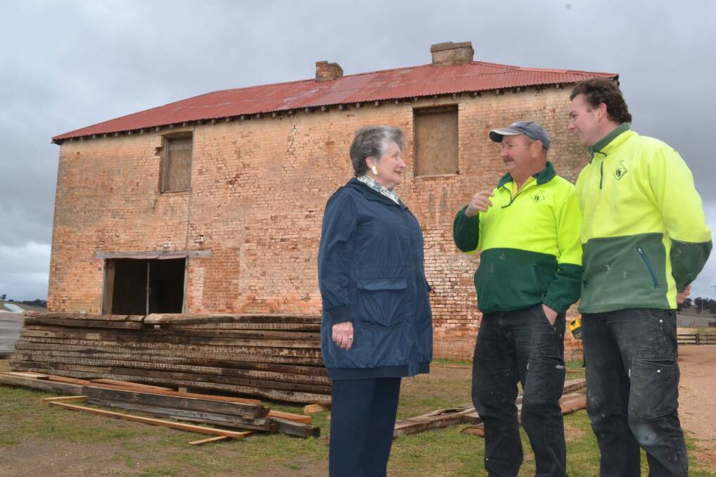 INTO THE PAST: Property owner Bonny Hennessy talks to builders Barry and Sam Harris outside the convict barracks.