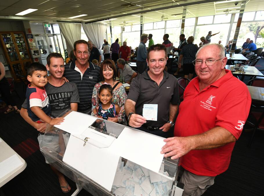 FUNDRAISER: Ashwin, 3, Brad, Glen, Kerry and Amira Buttsworth, 6, Member for Bathurst Paul Toole, who was given the job of drawing the winning ticket, and event organiser Tony Wise. Photos: CHRIS SEABROOK 021019cpool2
