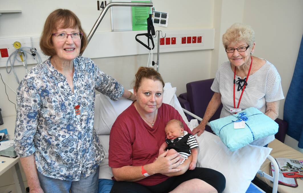 GIFT: Bathurst Base Hospital Auxiliary's Jill Mitchell and Aileen Hough present a shawl to Sarah Mobbs, who had the first baby in Bathurst for 2018. Photo: CHRIS SEABROOK 010218caux1