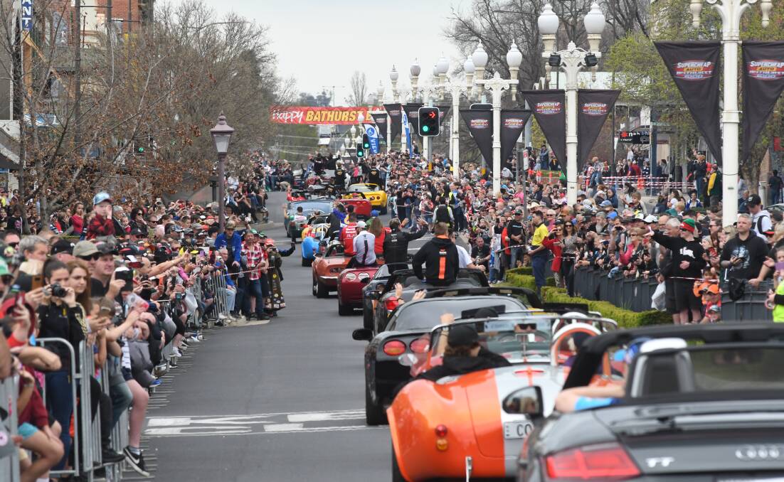 STANDING ROOM: The parade of drivers and transporters attracted a big crowd, but is enough being done to bring Race Week into the city's heart? Photo: CHRIS SEABROOK