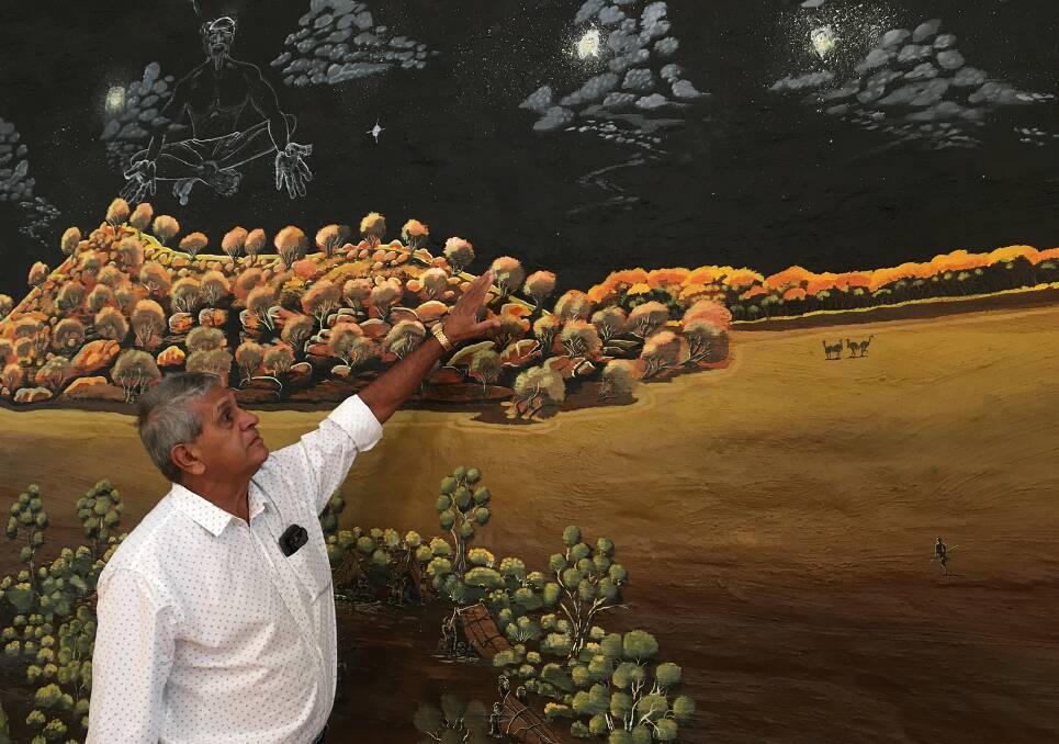 STARS ARE OUT: Wiradjuri Condobolin Corporation CEO Ally Coe pointing at the stars as painted by Darren Cooper in his mural in the Condobolin Wiradjuri Study Centre's art room. Photo: MERRILL FINDLAY