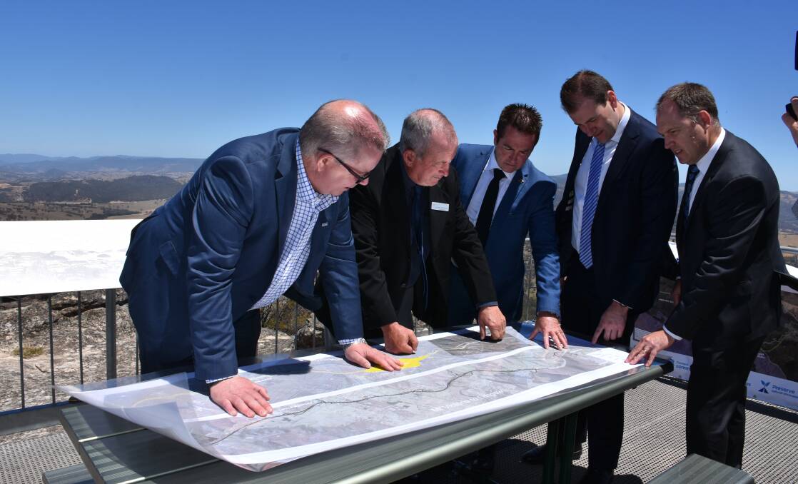 PLAN: Transport for NSW western region director Alistair Lunn, Bathurst mayor Bobby Bourke, Member for Bathurst Paul Toole, Nationals MLC Sam Farraway and Orange City Council's technical services director Wayne Gailey looking at plans for the highway duplication at an announcement in November last year.