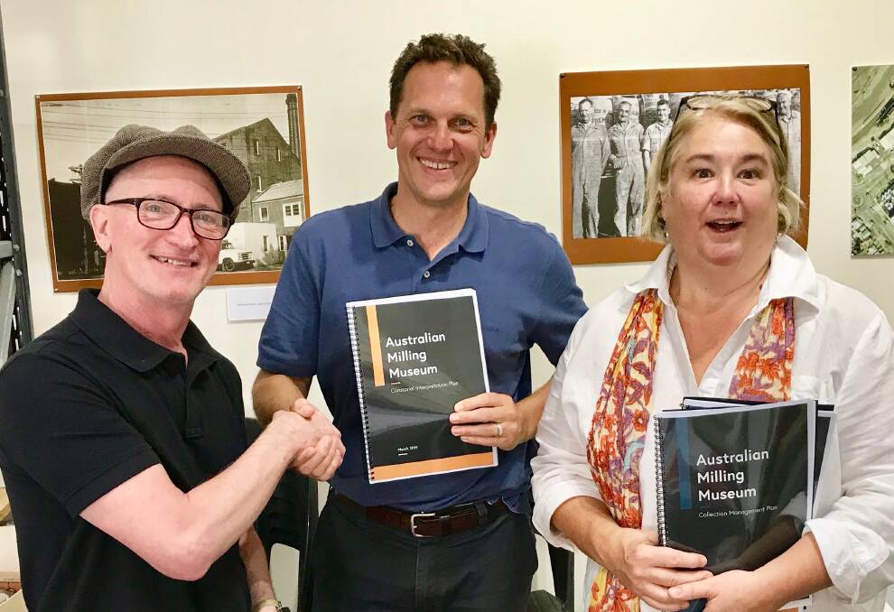 HANDOVER: Stephen Thompson from Australian Curatorial Services hands the Australian Milling Museum's Curation Plan and Collection Policy to Jess Jennings and Samantha Friend.