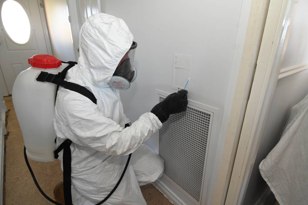 MONITORING: Daniel Taurins checks for contamination near a vent. Photo: JUDE KEOGH