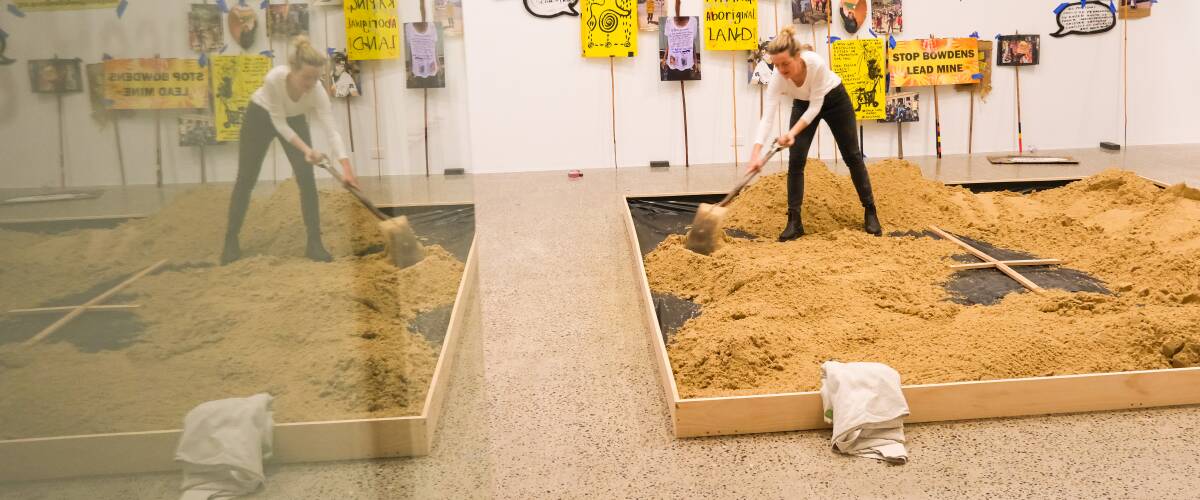 Acting exhibitions co-ordinator Alex Robinson getting the raw materials in place for artist Aleshia Lonsdale's sand painting at Bathurst Regional Art Gallery. Picture by James Arrow. 