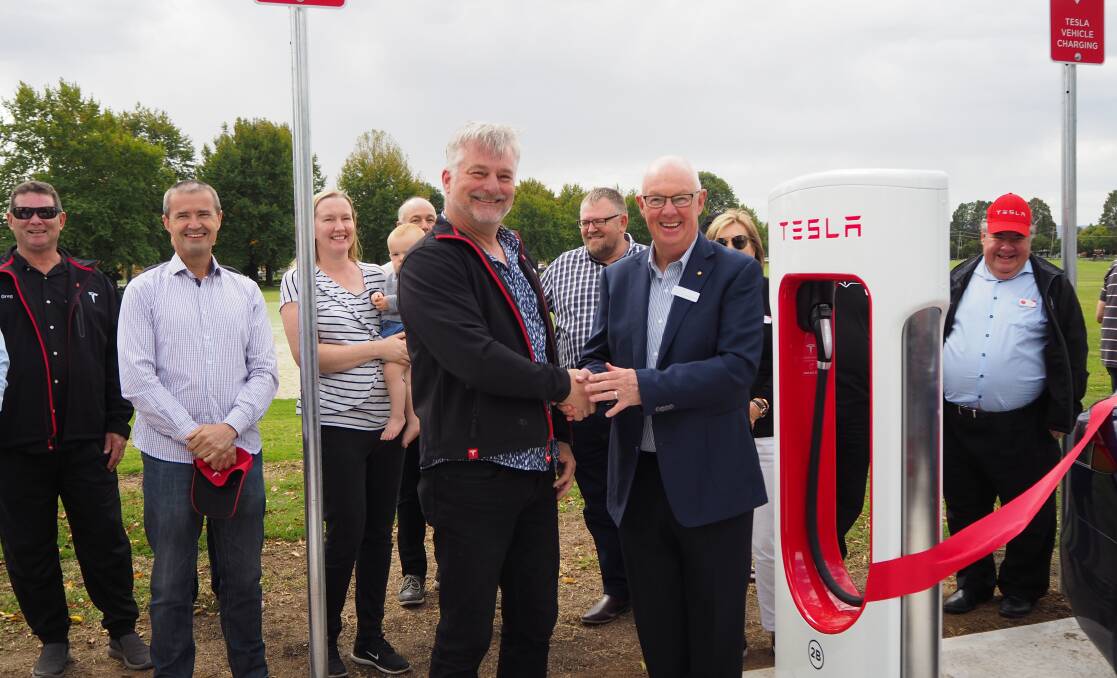 ELECTRIC AVENUE: Tesla Owners Club of Australia president Mark Tipping and mayor Graeme Hanger at the opening of Bathurst's first permanent Tesla Supercharger station in April last year. Photo: SAM BOLT 040919sbtesl1
