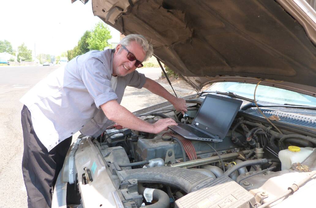TECH SUPPORT: Shane Summerton from Bathurst Library tunes up his car with the help of the Haynes online repair manuals.