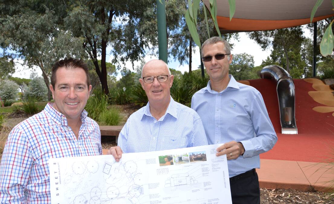 NEXT STAGE: Member for Bathurst Paul Toole, mayor Graeme Hanger and
Bathurst Regional Council’s manager of recreation Mark Kimbel with plans for stage
two of the Adventure Playground.