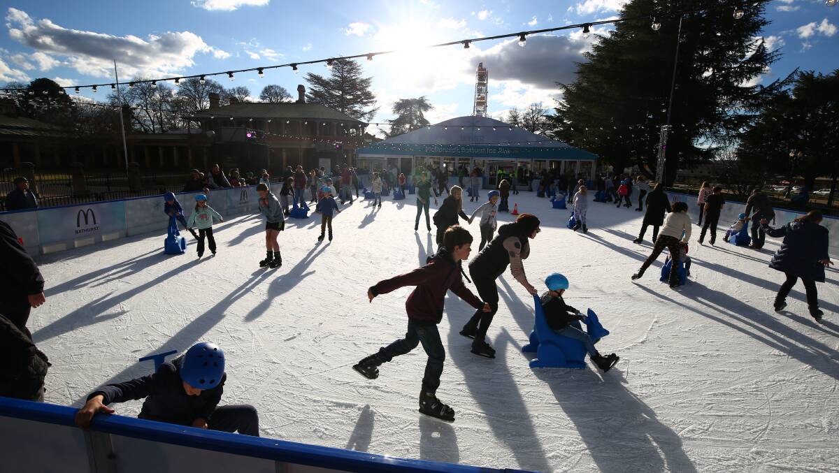 OPPORTUNITY: Working at the Bathurst Winter Festival, which featured an ice rink, among other attractions, was a chance to learn new skills for two clients of LiveBetter. Photo: PHIL BLATCH 071118pbsnap2