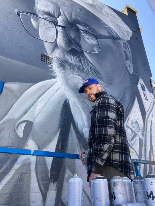 Callum Hotham working on his latest mural project in Blayney. Picture by Mark Logan.