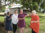 CONCERN: Jenny Beach, Helen Russ, Mary-Liz Andrews and Anne Harrison in front of the historic bluestone cottage on Millthorpe's Park Street. A proposed development will be in behind the cottage. Photo: MARK LOGAN