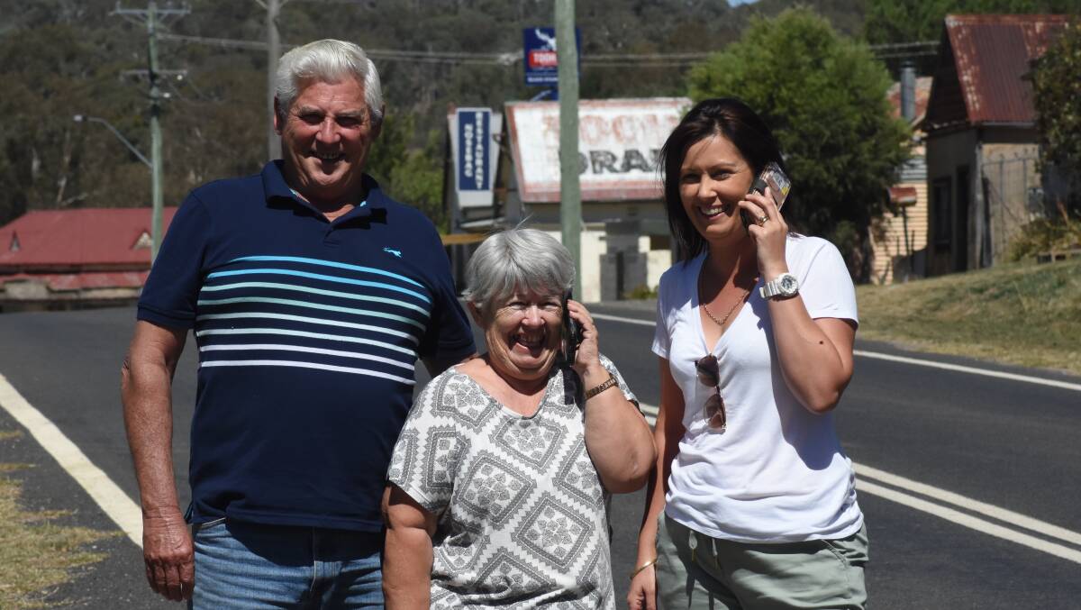 Tuning in: Mike and Marilyn Burke and Erin Johns with their operational mobile phones in Trunkey Creek.