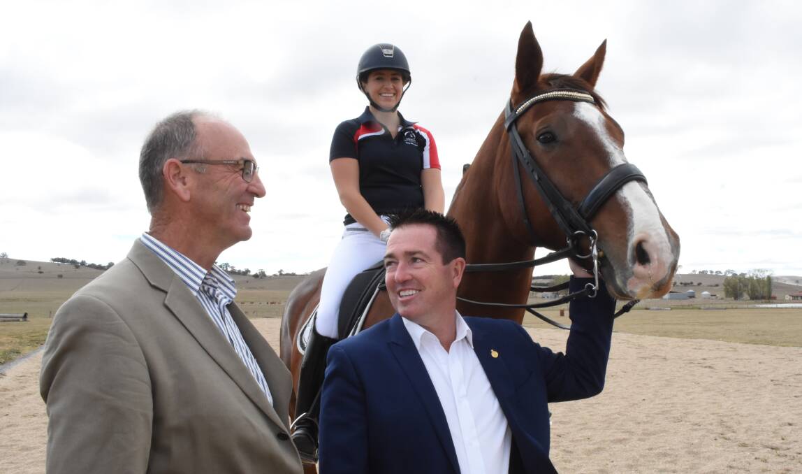 ALL SMILES: Scott Ferguson and Paul Toole, along with Bathurst rider Sarah Farraway, at the site of the new equestrian centre in Blayney. Photo: MARK LOGAN