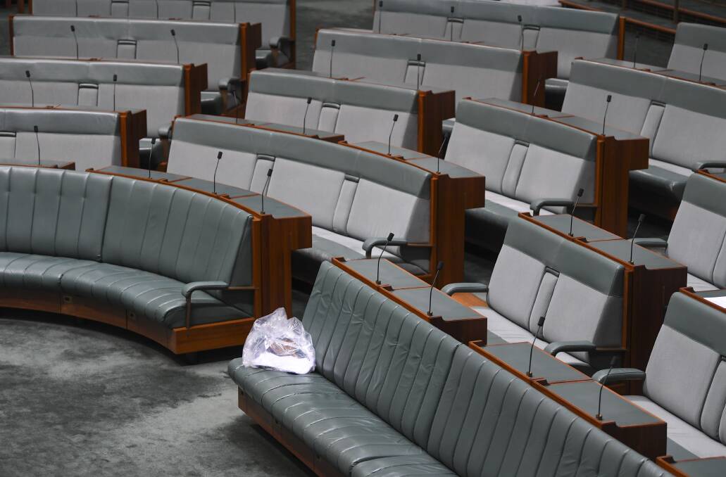 A rubbish bag is seen in the chamber after a vote to adjourn the House of Representatives at Parliament House in Canberra. Photo: AAP Image/Lukas Coch