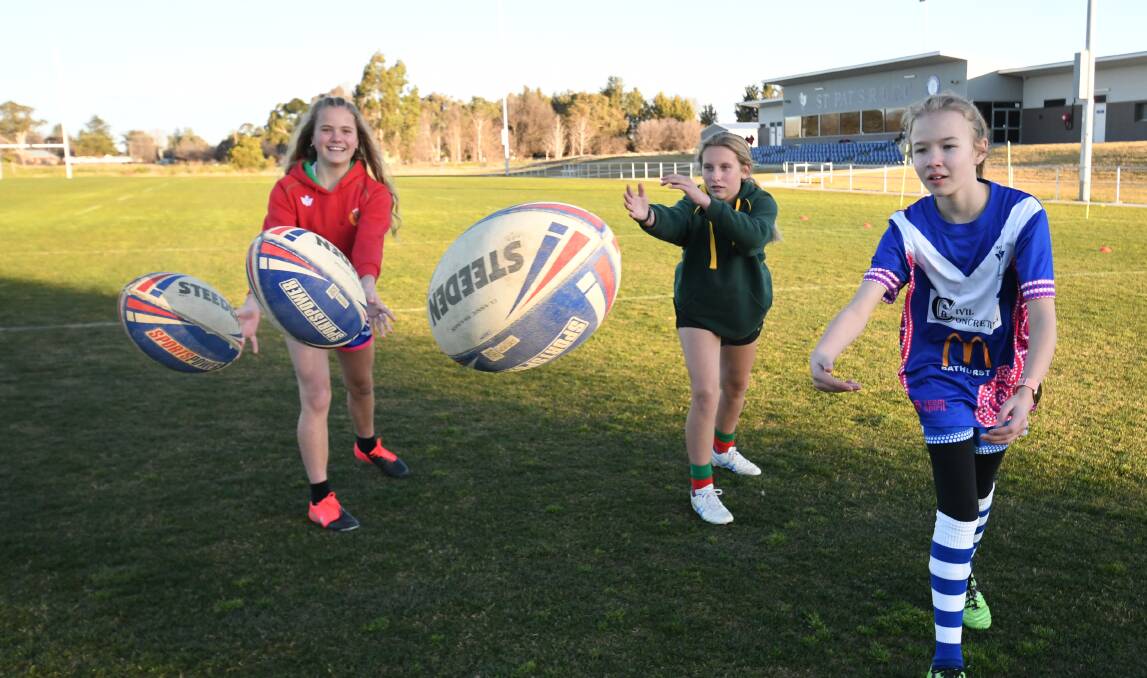 READY TO HAVE A BALL: St Pat's under 13s, from left, Tarnya Kelleher (12), Olivia Bednal (11) and Maddy Kupkee (12) can't wait for the start of the league tag season. Photo: CHRIS SEABROOK 070120cjnrtag1