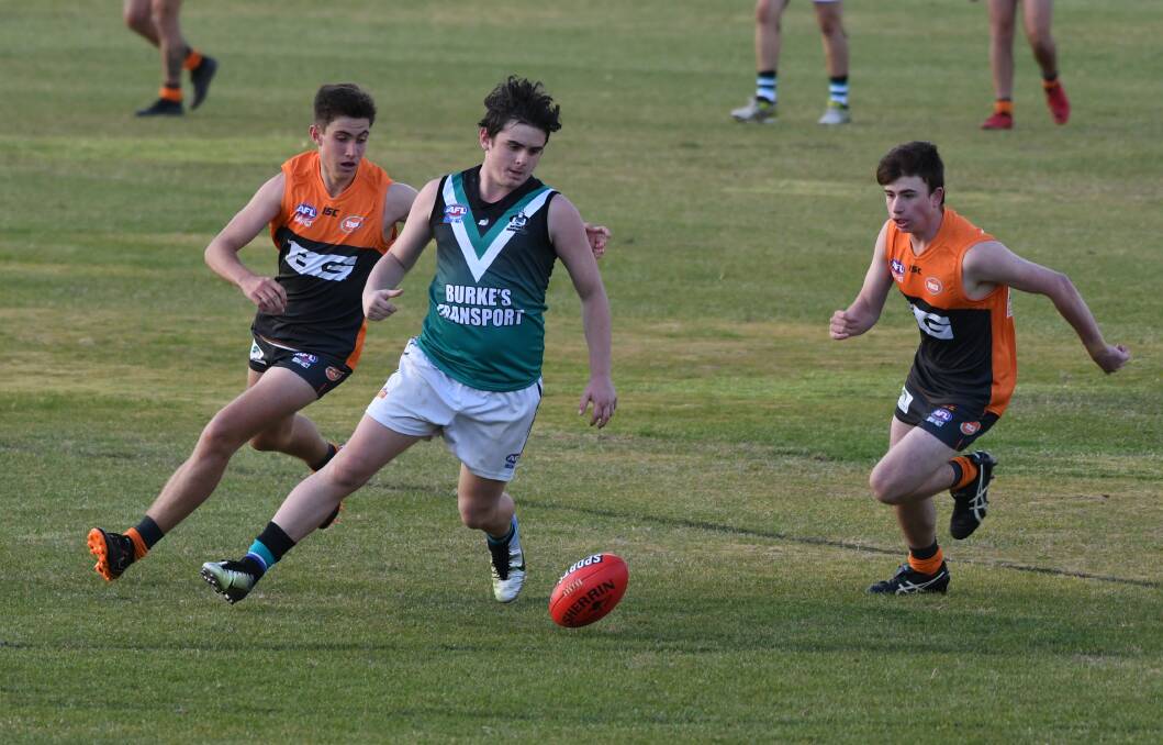 GOOD RIVALRY: Bathurst Bushrangers Outlaws' Michael Long works to win the ball in Saturday's Central West AFL match against the Bathurst Giants. Photo: CHRIS SEABROOK