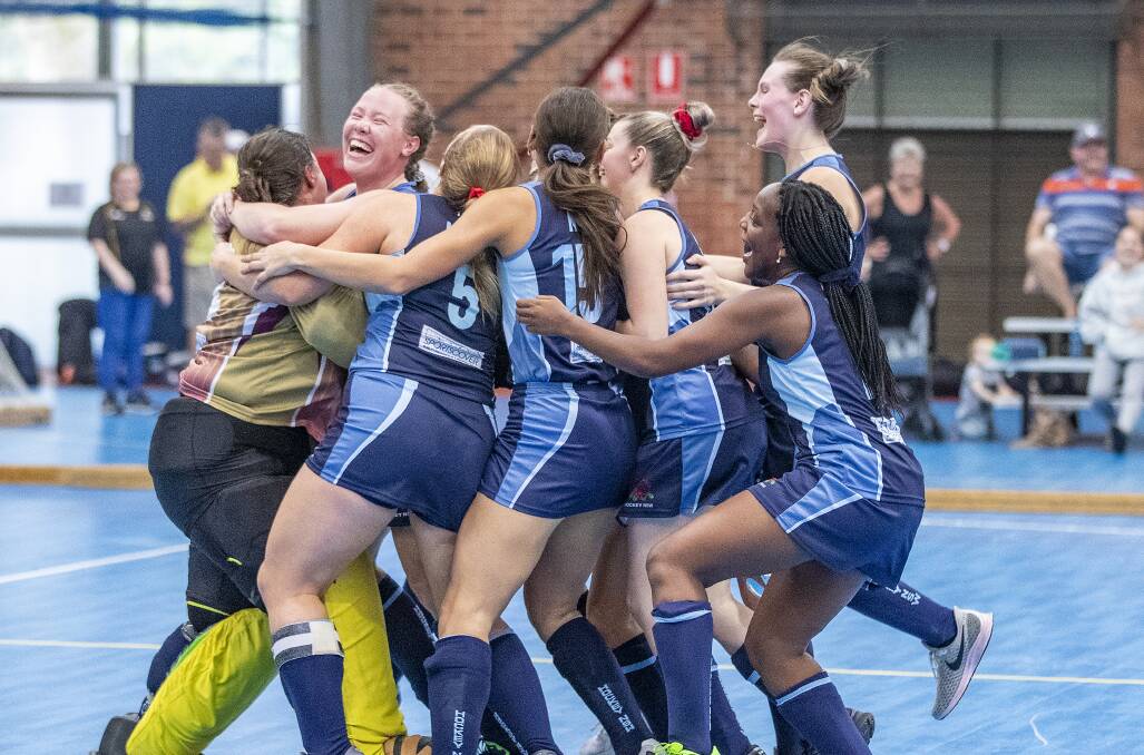 THE JUBE: Sarah Watterson and her NSW Blue team-mates celebrate after claiming a surprise gold medal. Photo: CLICK INFOCUS/HOCKEY AUSTRALIA