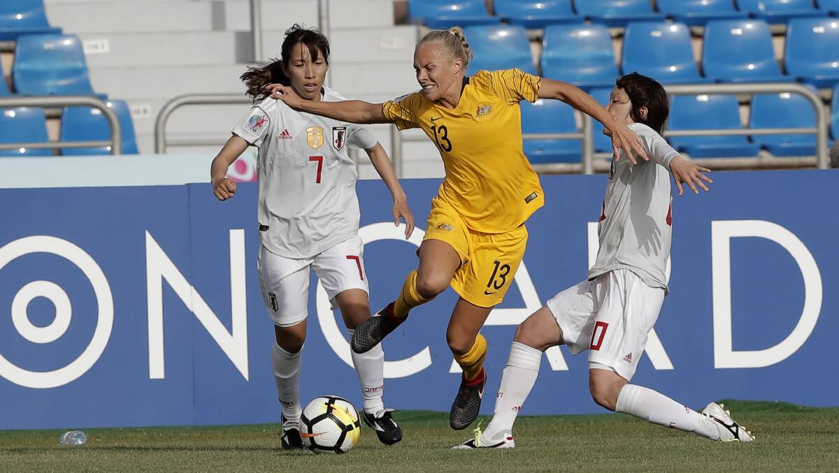 CUP SEEKER: Tameka Butt, pictured fighting for control of the ball against Japan's Emi Nakajima and Mizuho Sakaguchi, would love to hoist the Asian Cup.