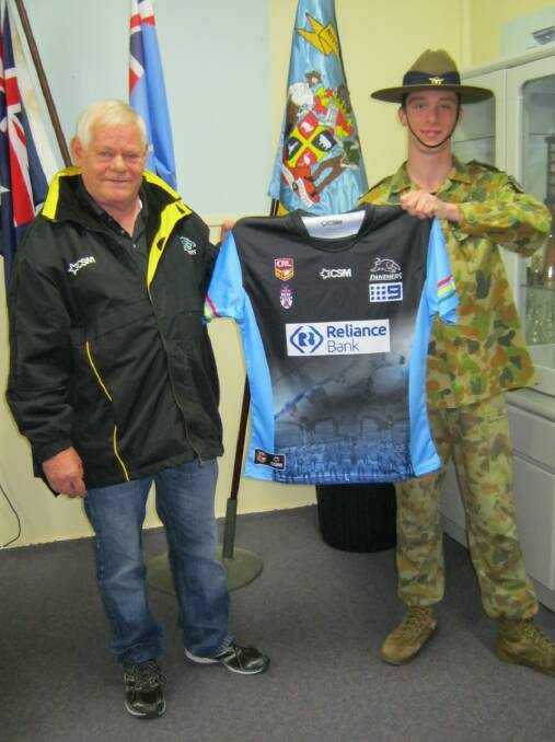 SPECIAL JERSEY: Bathurst Panthers president Dennis Comerford presents the Bathurst Squadron of the Air Force Cadets one of the special ANZAC Day jumpers. The cadets will lead the Panthers and St Pat's players out on to the field prior to the match.