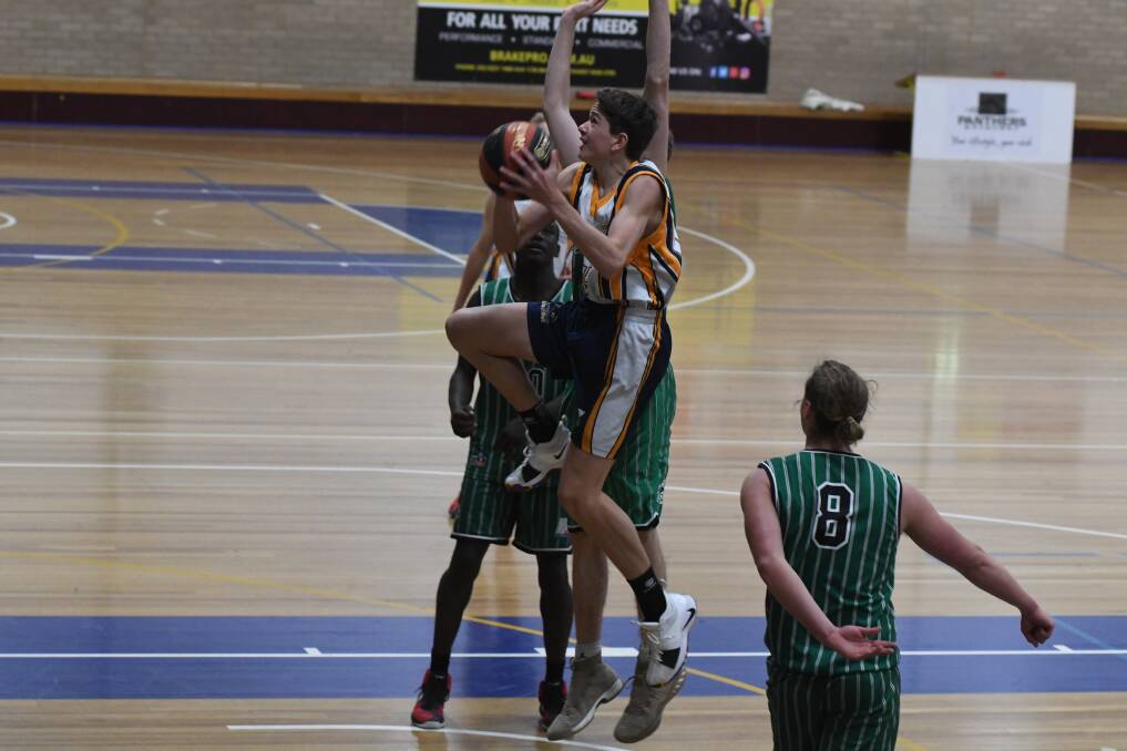 FLYING HIGH: Bathurst Goldminer Ben Matthews jumps towards the basket in Saturday's match against Hornsby. Photo: CHRIS SEABROOK