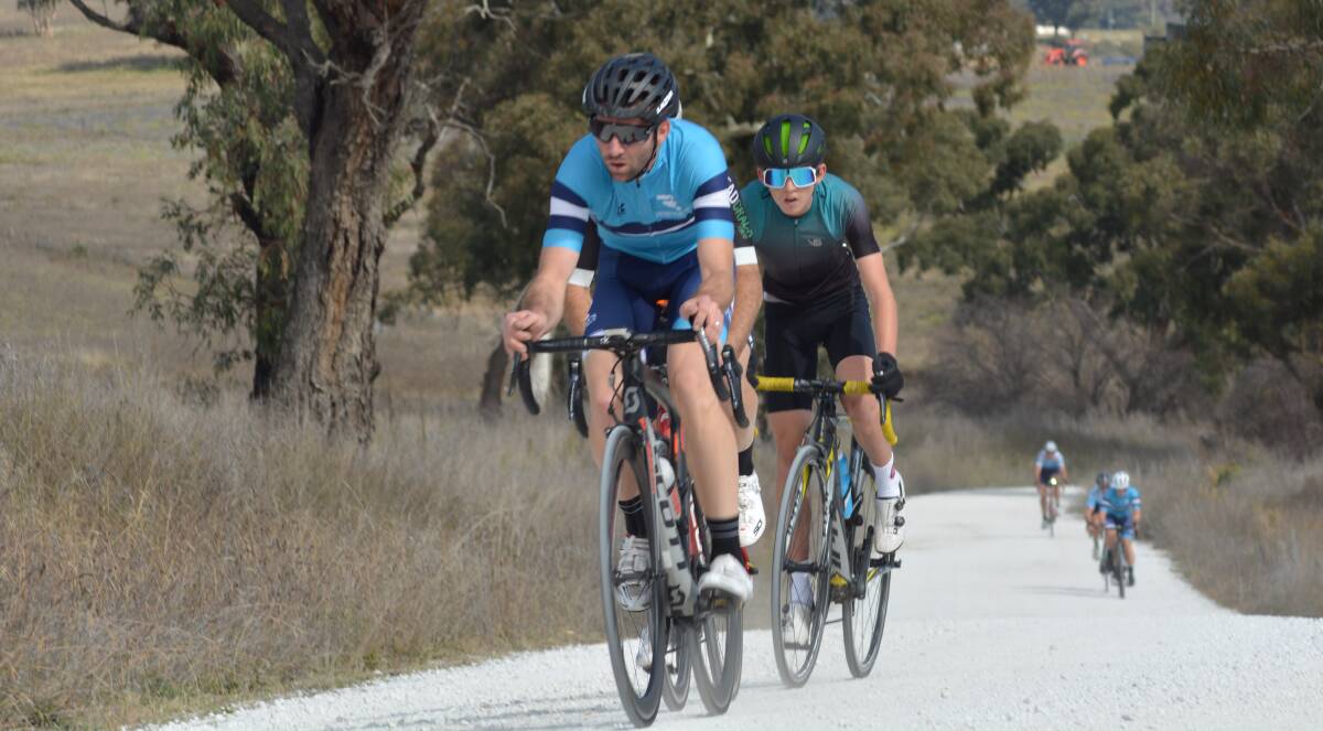LEAD BUNCH: Craig Hutton, with talented teen Cadel Lovett on his wheel, works to gap the A grade chasers in the Bathurst Cycling Club's Hurt on the Dirt. Photo: JOANNE RENSHAW