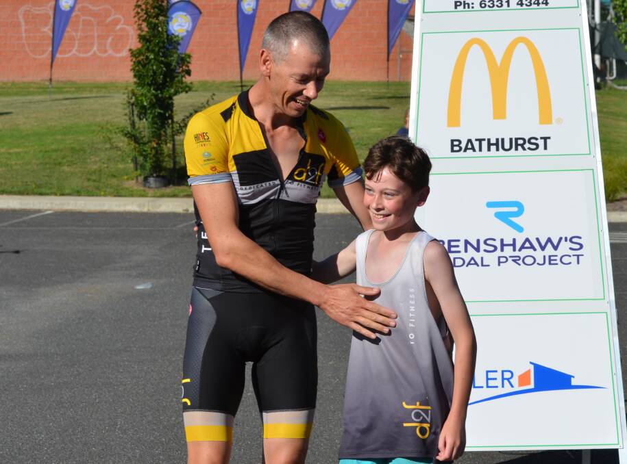 PROUD MOMENT: Dan Watson congratulates his son Hayden after Sunday's short course triathlon. The Watsons competed as a team, with Hayden doing the run leg. Photo: ANYA WHITELAW