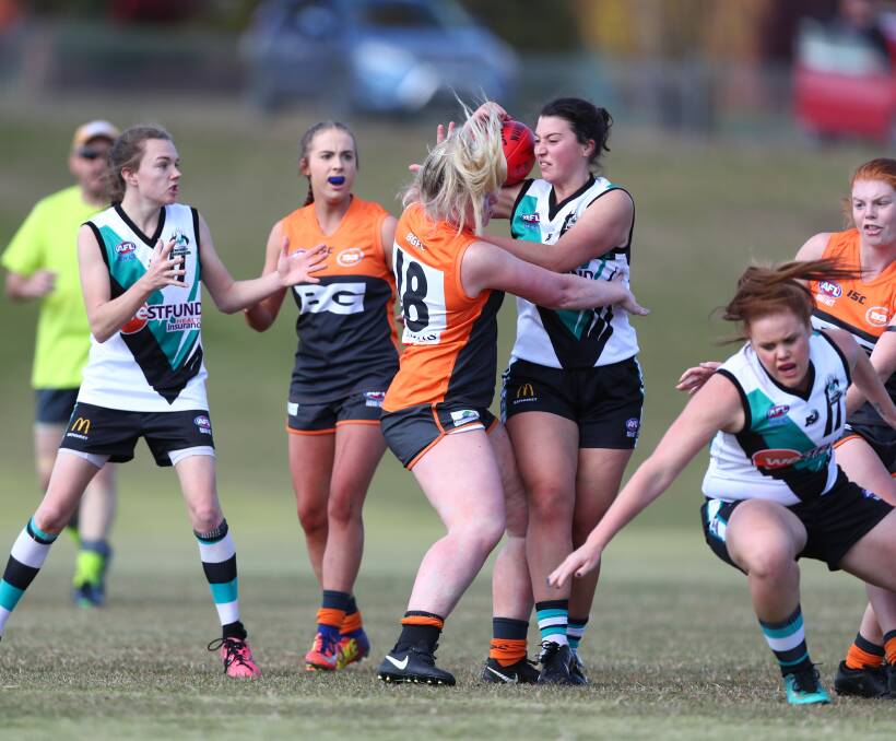 CONTEST: Lady Bushrangers' Carla Arcuri tries to break the tackle of Giants' rival Olivia Flood in Saturday's Central West AFL derby. Photo: PHIL BLATCH 051918pbgaints1