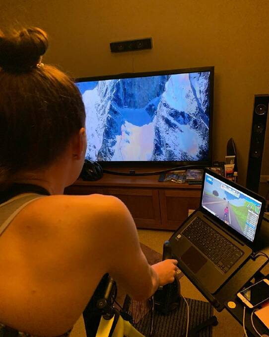 ON THE JOB: Emily Watts watches an Everest movie while making her virtual ascent of the renowned mountain. Photo: RACE WITH ME EMILY WATTS FACEBOOK
