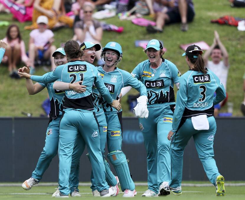 THE JOY: Brisbane Heat players celebrate their thrilling final-ball win against Lisa Griffith's Sydney Thunder in Saturday's Women's Big Bash League semi-final at Drummoyne Oval. Photo: AAP
